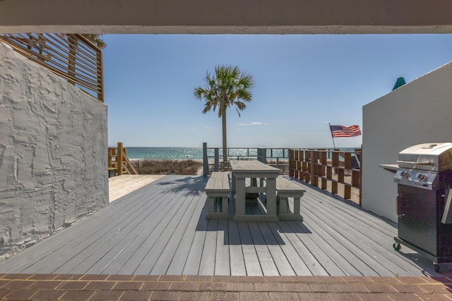 wooden deck with grilling area and a water view