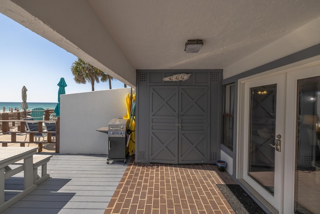 exterior space with a grill and a water view