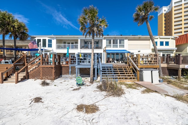 back of property with stairway and a wooden deck