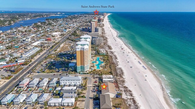 drone / aerial view featuring a beach view and a water view