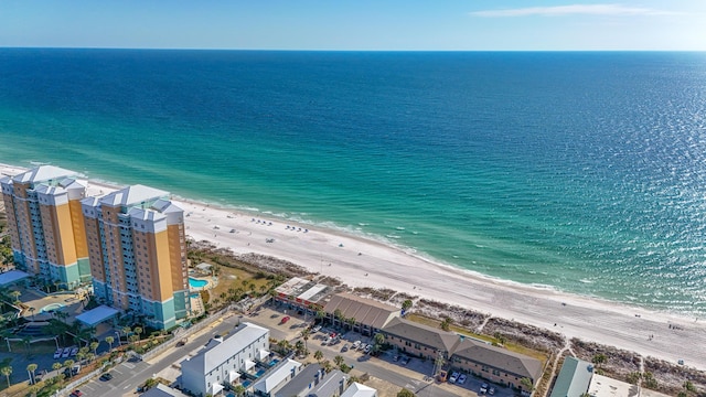 bird's eye view featuring a water view and a beach view