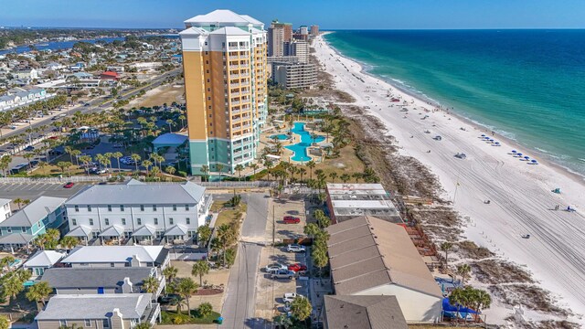 drone / aerial view with a water view and a beach view