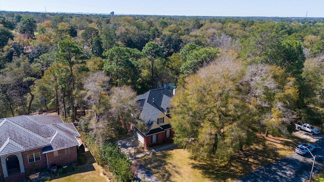 drone / aerial view featuring a view of trees