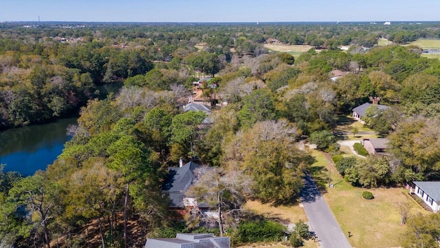 aerial view with a forest view and a water view