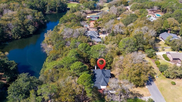 drone / aerial view with a view of trees and a water view