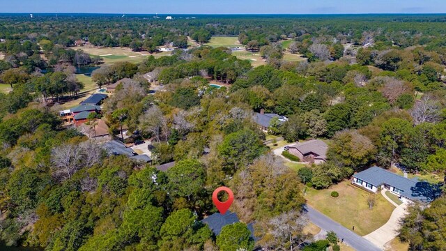 birds eye view of property featuring a wooded view