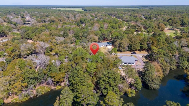 bird's eye view featuring a view of trees and a water view