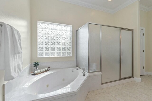 bathroom featuring tile patterned floors, a tub with jets, a stall shower, and ornamental molding