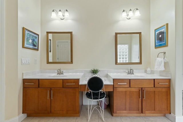 bathroom with tile patterned floors, vanity, and baseboards