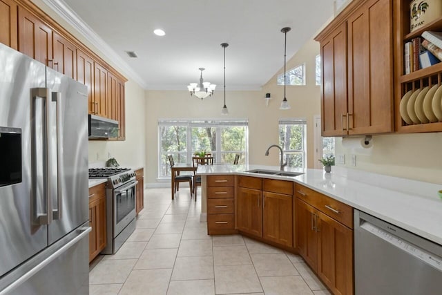 kitchen with a sink, stainless steel appliances, ornamental molding, and brown cabinetry