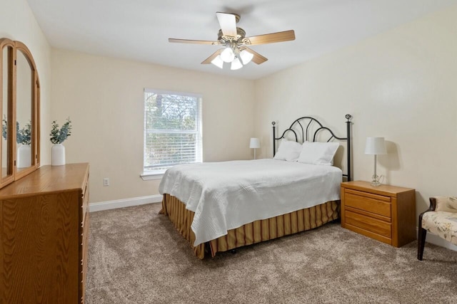 carpeted bedroom with a ceiling fan and baseboards