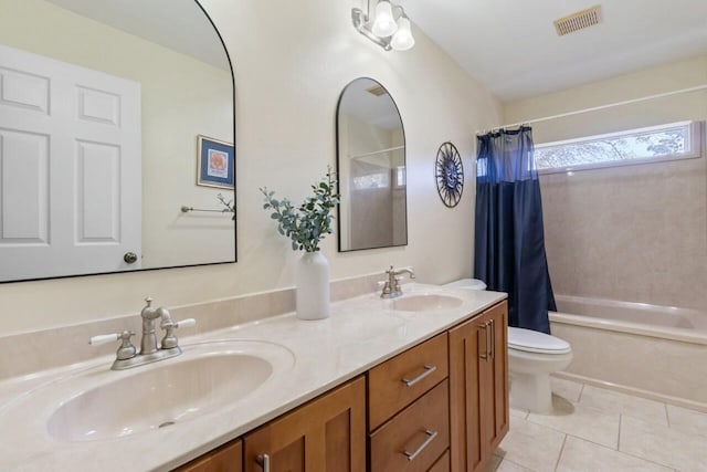 bathroom featuring tile patterned floors, visible vents, toilet, and a sink