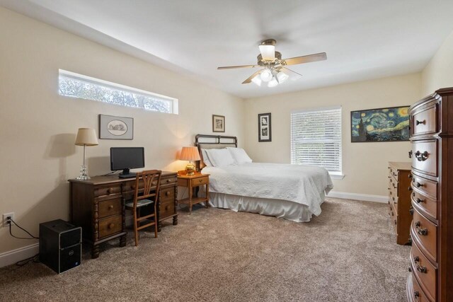 carpeted bedroom with baseboards and ceiling fan