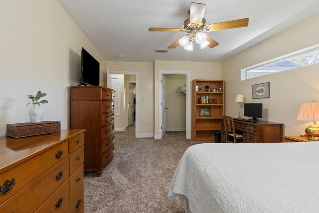 bedroom with a ceiling fan, visible vents, baseboards, a closet, and light colored carpet