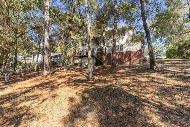 view of yard featuring stairs and a deck