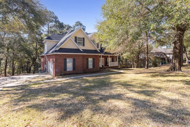 view of front of house featuring a garage, brick siding, concrete driveway, and a front yard