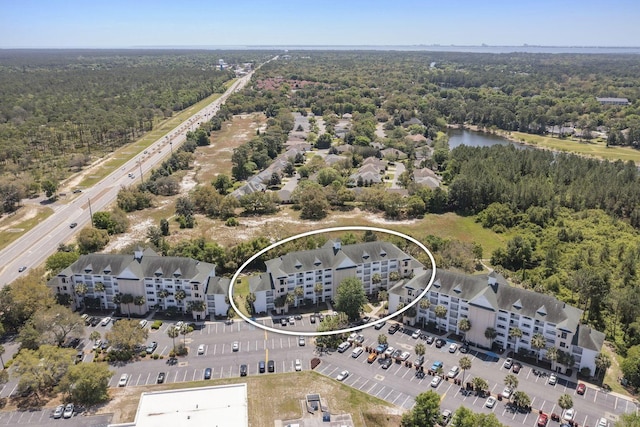 bird's eye view with a wooded view and a water view