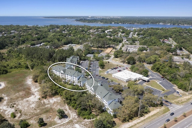 bird's eye view featuring a view of trees and a water view