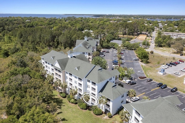 birds eye view of property with a view of trees