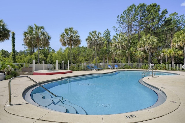 pool with fence, a community hot tub, and a patio area