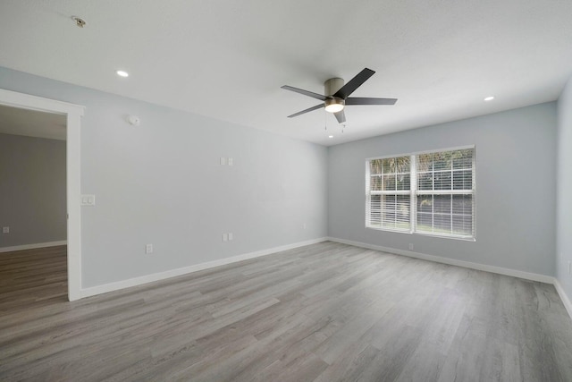 spare room with recessed lighting, wood finished floors, baseboards, and ceiling fan