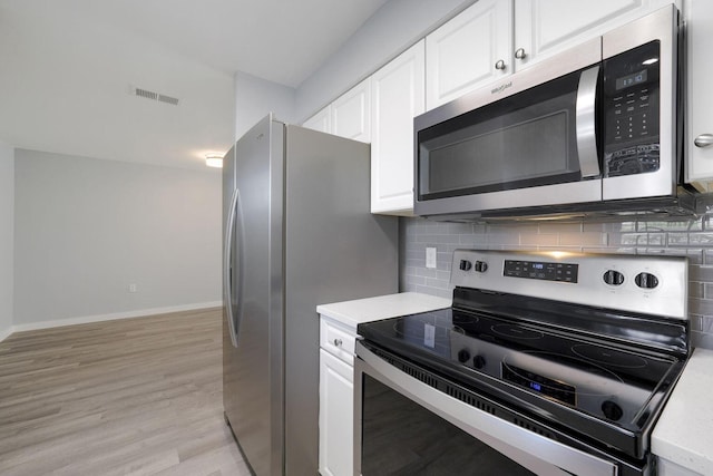 kitchen with visible vents, appliances with stainless steel finishes, white cabinetry, and light countertops