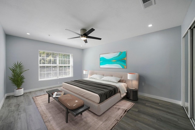 bedroom with recessed lighting, wood finished floors, visible vents, and baseboards