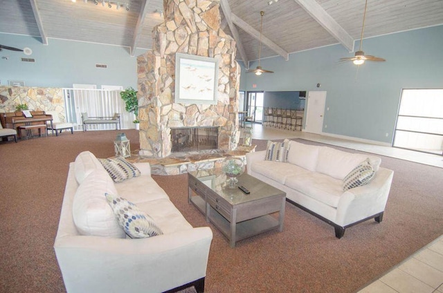 carpeted living area featuring a stone fireplace, beam ceiling, wooden ceiling, and high vaulted ceiling