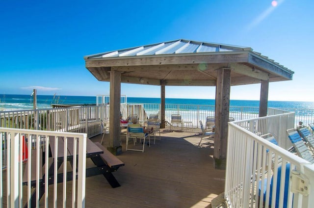 exterior space featuring a gazebo, a view of the beach, and a water view