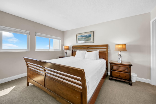 carpeted bedroom with baseboards