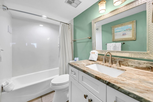 bathroom with vanity, toilet, tile patterned floors, visible vents, and shower / bath combo with shower curtain