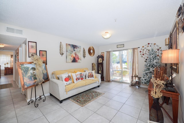 living area featuring visible vents, baseboards, and light tile patterned flooring