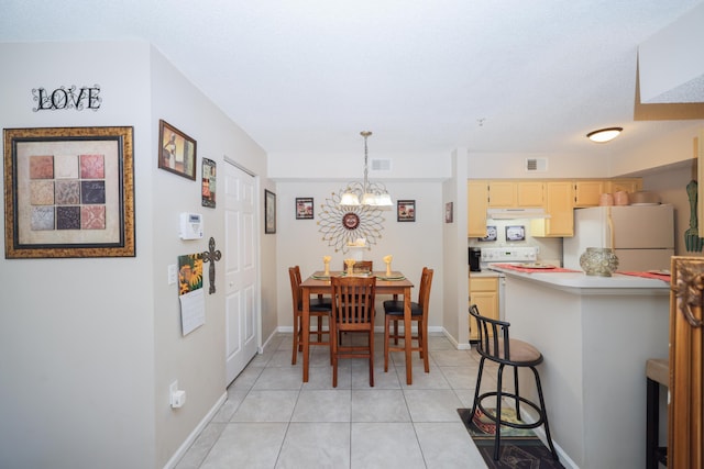 dining space with light tile patterned floors, visible vents, baseboards, and a notable chandelier