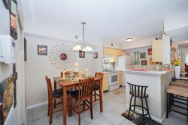 dining area featuring light tile patterned floors, visible vents, baseboards, and a notable chandelier