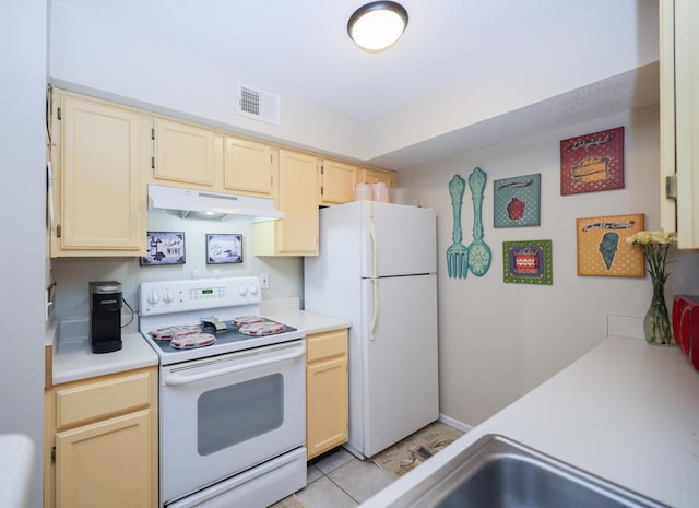 kitchen featuring white appliances, light countertops, visible vents, and under cabinet range hood