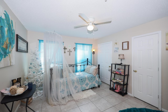 bedroom with light tile patterned flooring and a ceiling fan