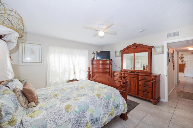 bedroom featuring visible vents, baseboards, light tile patterned flooring, and a ceiling fan