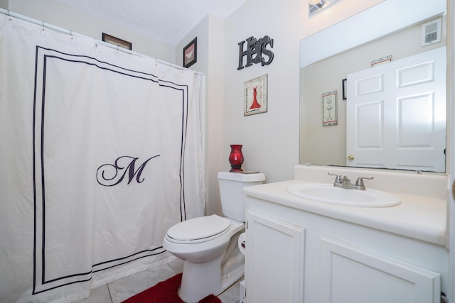 bathroom featuring vanity, toilet, and a textured ceiling