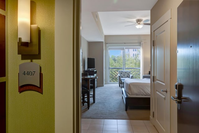 bedroom with access to exterior, carpet, tile patterned floors, and ceiling fan