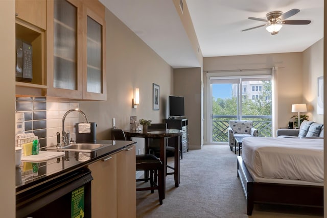 bedroom featuring access to exterior, light carpet, wine cooler, and a sink