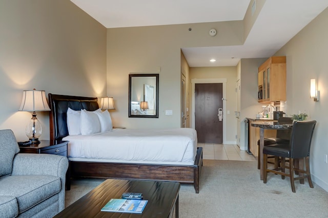 bedroom featuring recessed lighting, baseboards, light colored carpet, and light tile patterned flooring