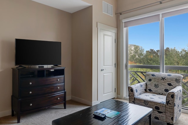 living room with light colored carpet, baseboards, and visible vents