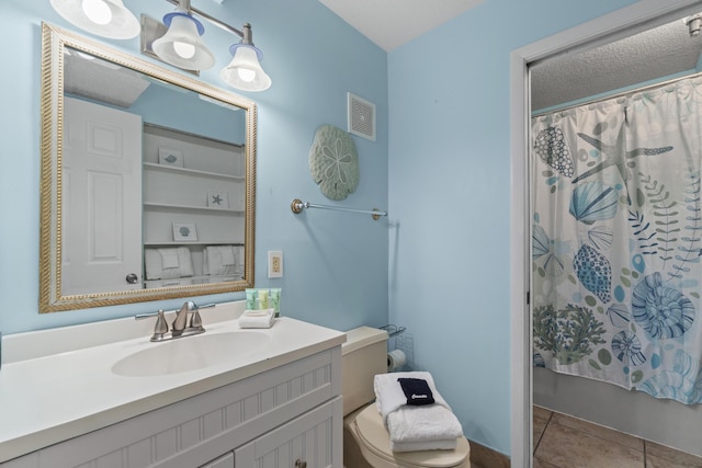 bathroom featuring tile patterned floors, visible vents, vanity, and shower / bath combo