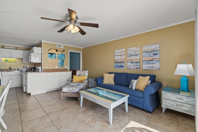 living area with light tile patterned flooring, visible vents, crown molding, and a ceiling fan