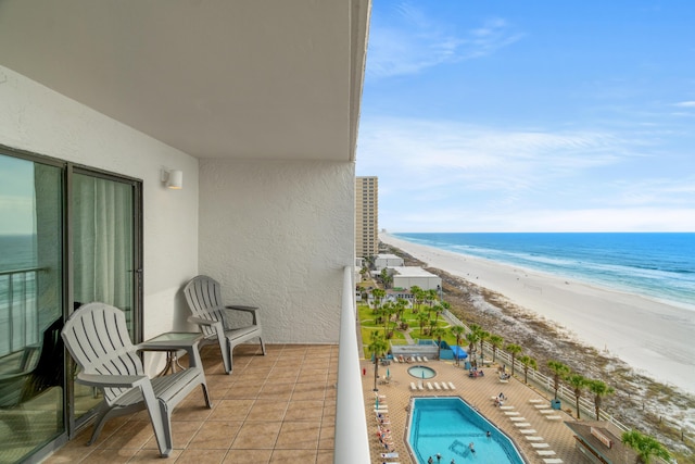 balcony with a beach view and a water view