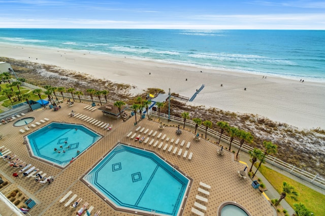 birds eye view of property with a water view and a view of the beach