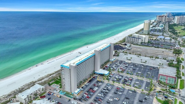 aerial view featuring a water view, a view of city, and a beach view