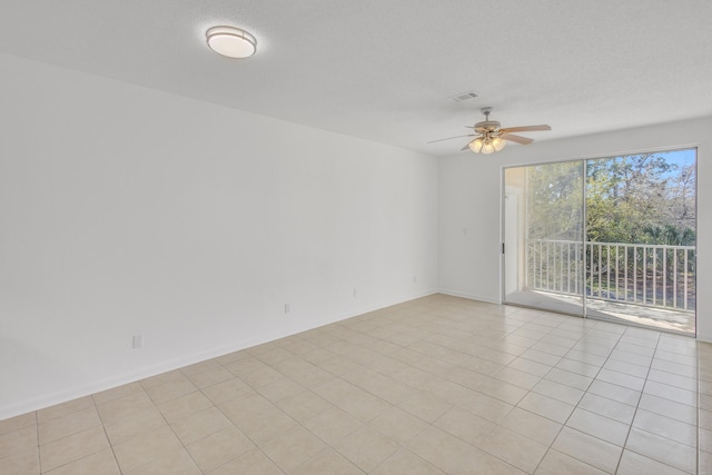 unfurnished room featuring baseboards, visible vents, a textured ceiling, and a ceiling fan