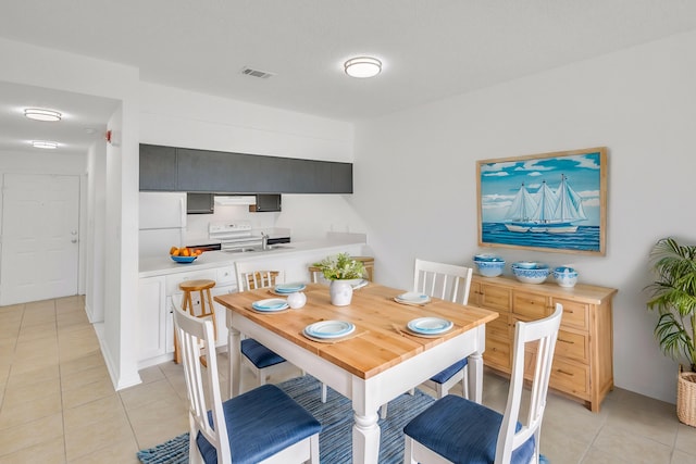 dining space featuring light tile patterned flooring and visible vents