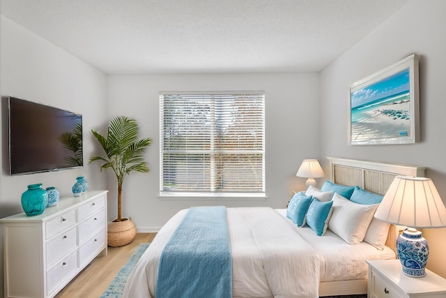 bedroom with light wood finished floors